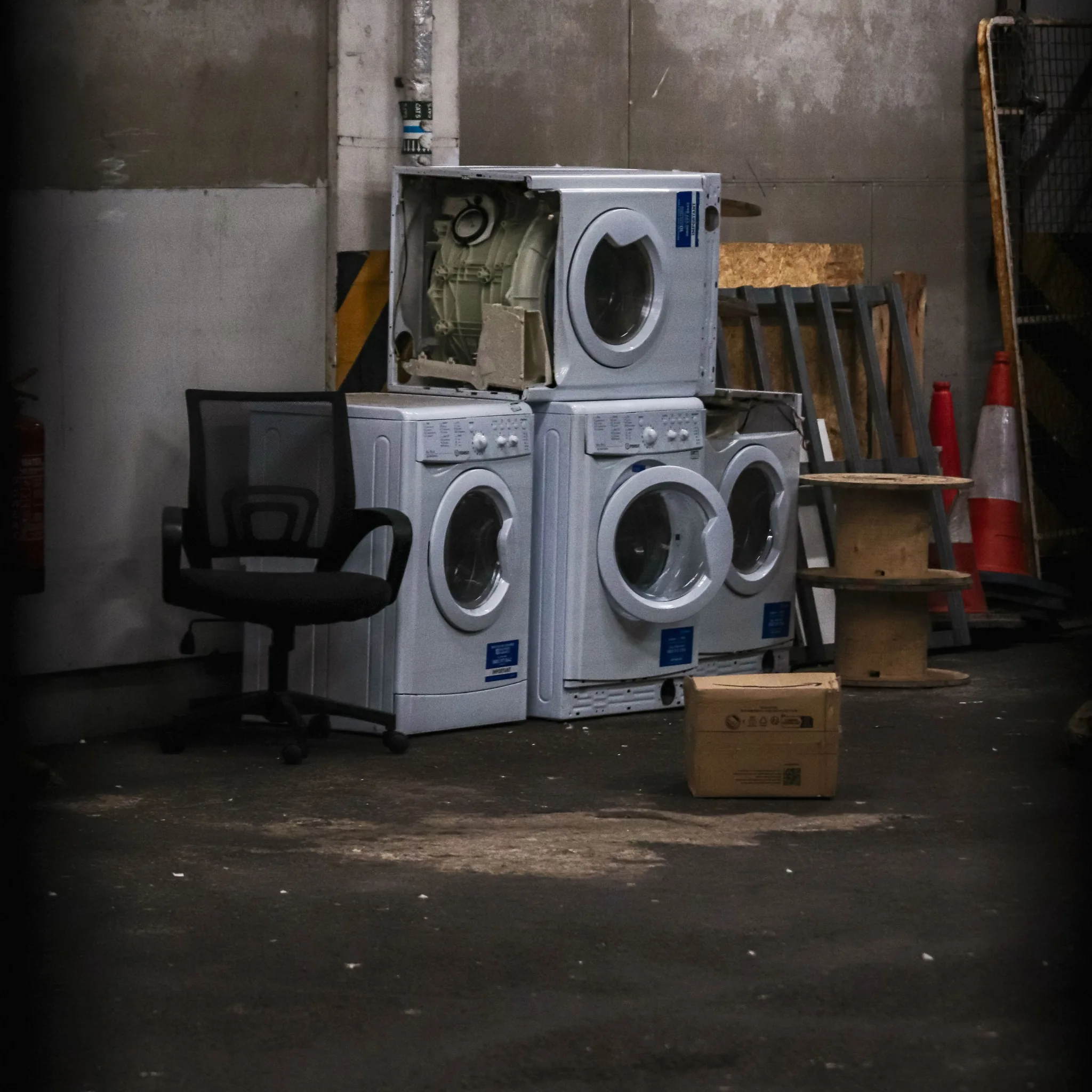 Old washing machines staged for haul-away