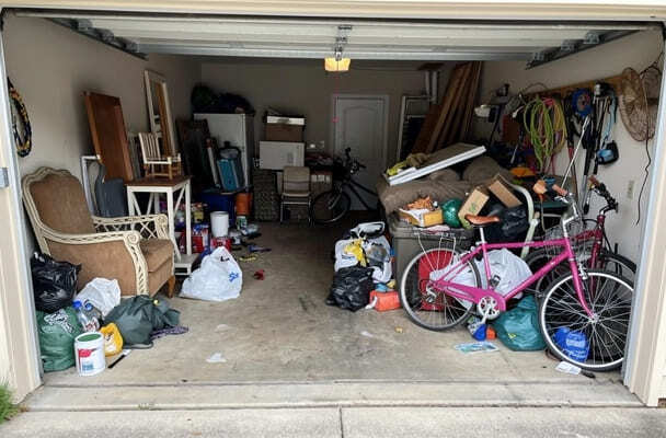 Cluttered garage filled with items for removal